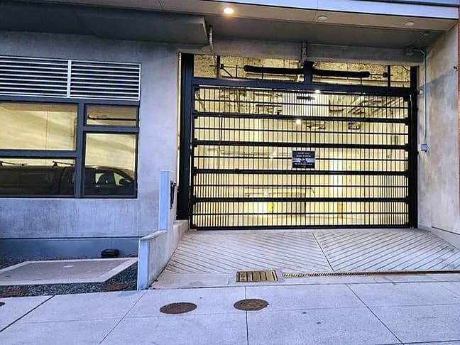 See-through parkade security gate — Strata building entrance, Up & Down Garage Doors job