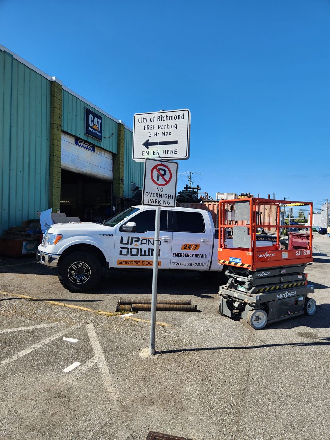 Up and Down service truck and scissor lift at a Richmond commercial door job