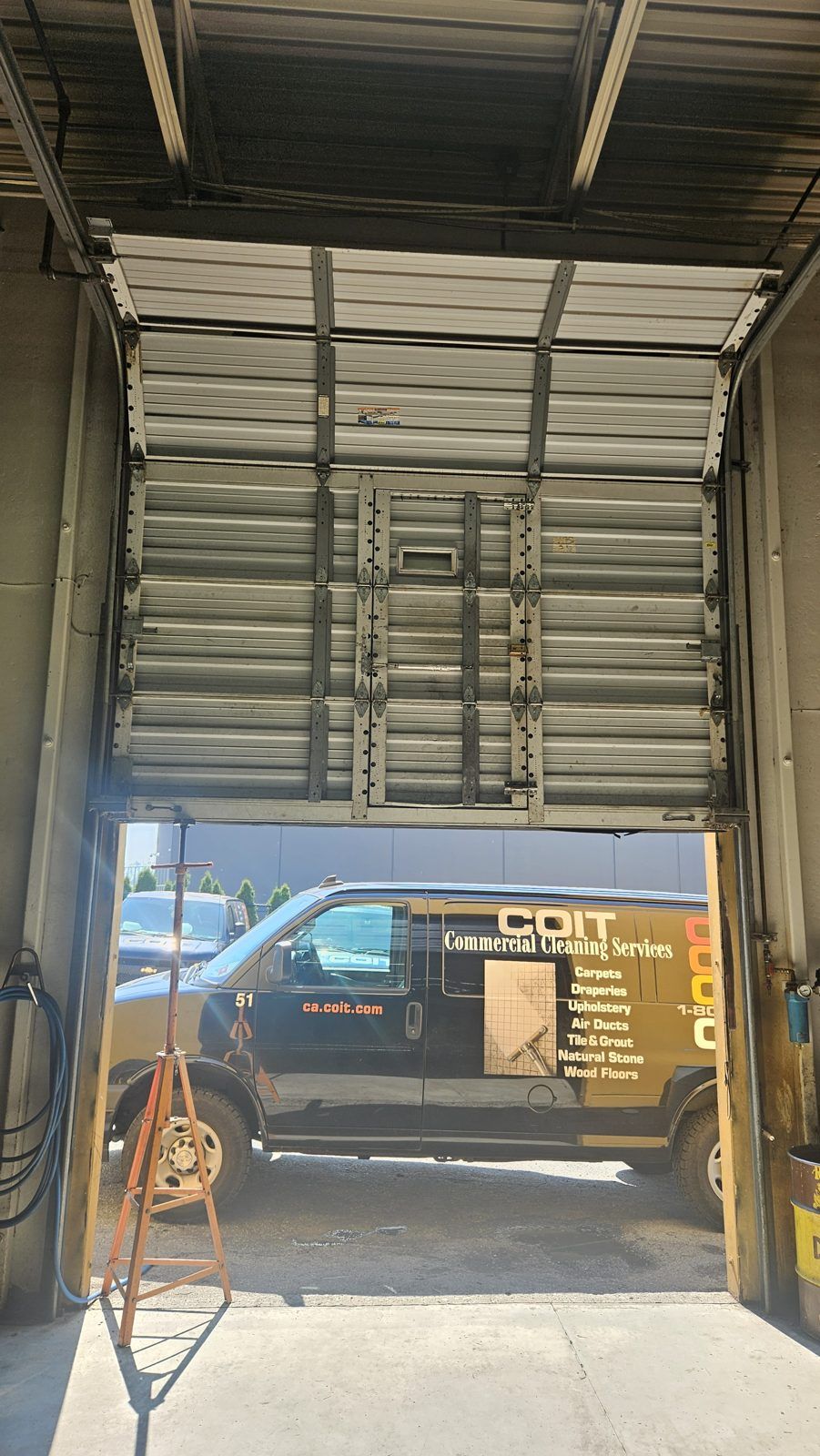 Commercial overhead door opened for service at a warehouse bay