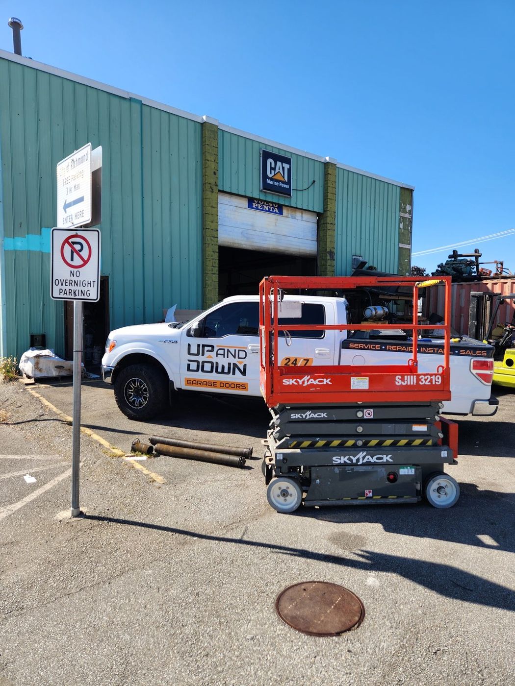 Scissor lift set up for commercial garage door work in Richmond BC
