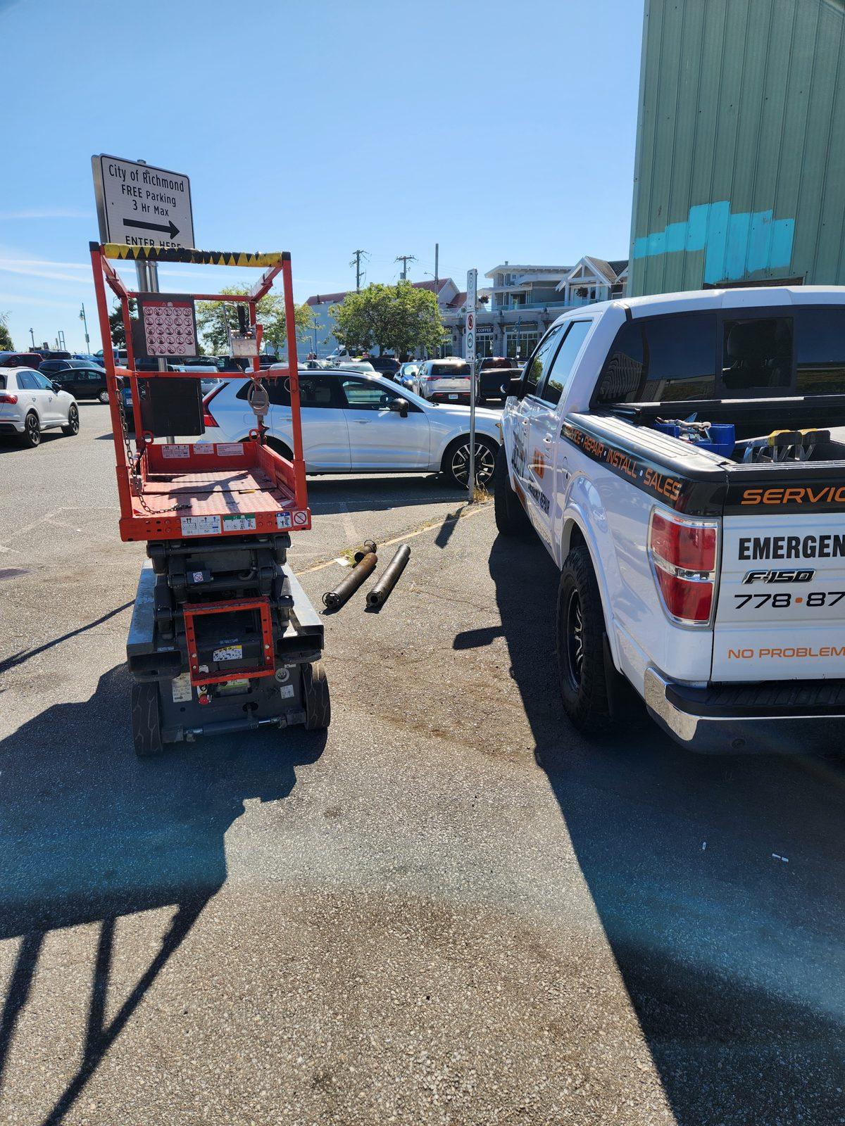 High-clearance commercial door repair from a scissor lift in Richmond BC