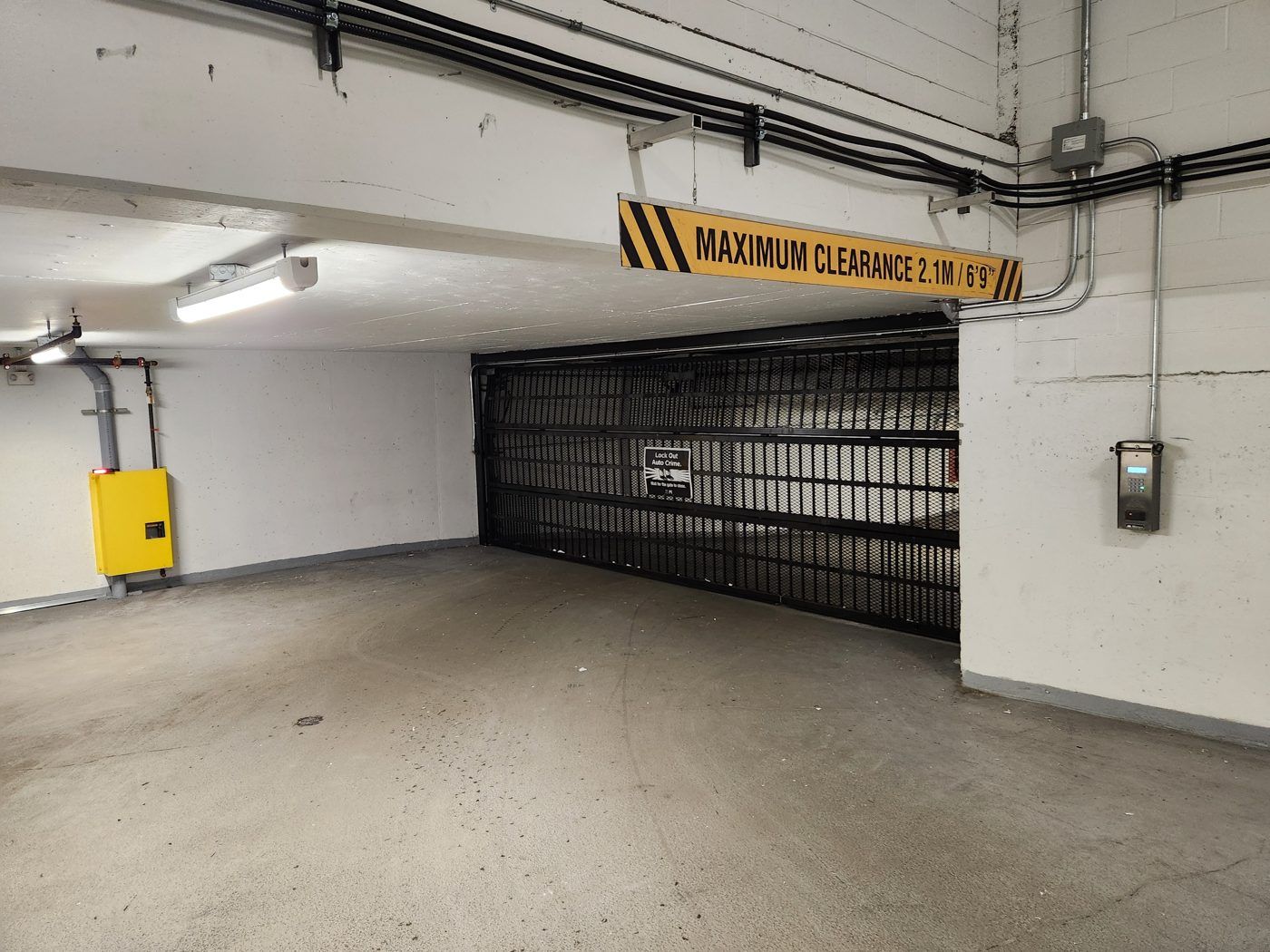 Commercial parkade gate and clearance signage serviced by Up and Down Garage Doors, Metro Vancouver