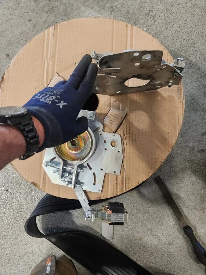 Garage door opener drive gear assembly held during a repair