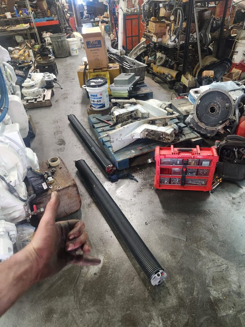 snapped garage door spring at an auto shop