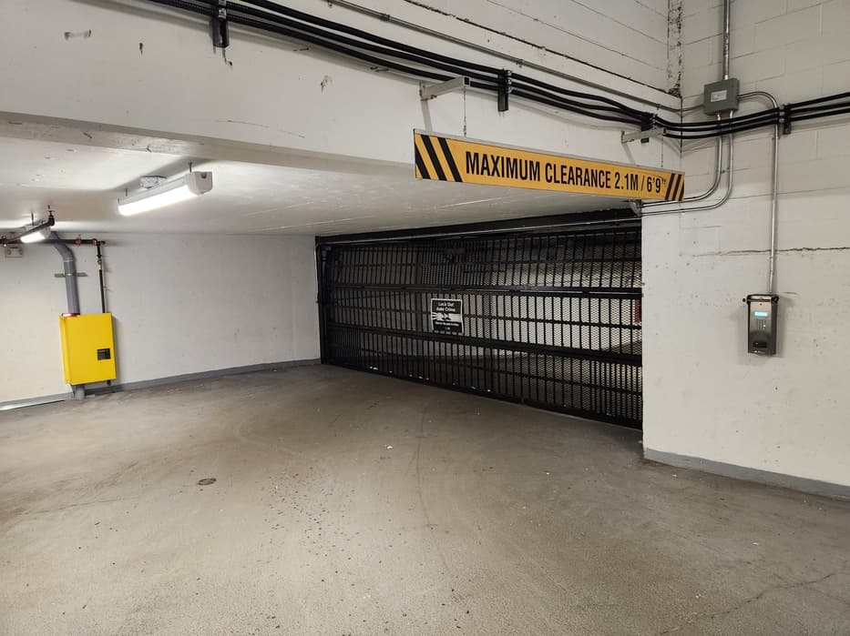 Commercial parkade gate and clearance signage serviced by Up and Down Garage Doors, Metro Vancouver